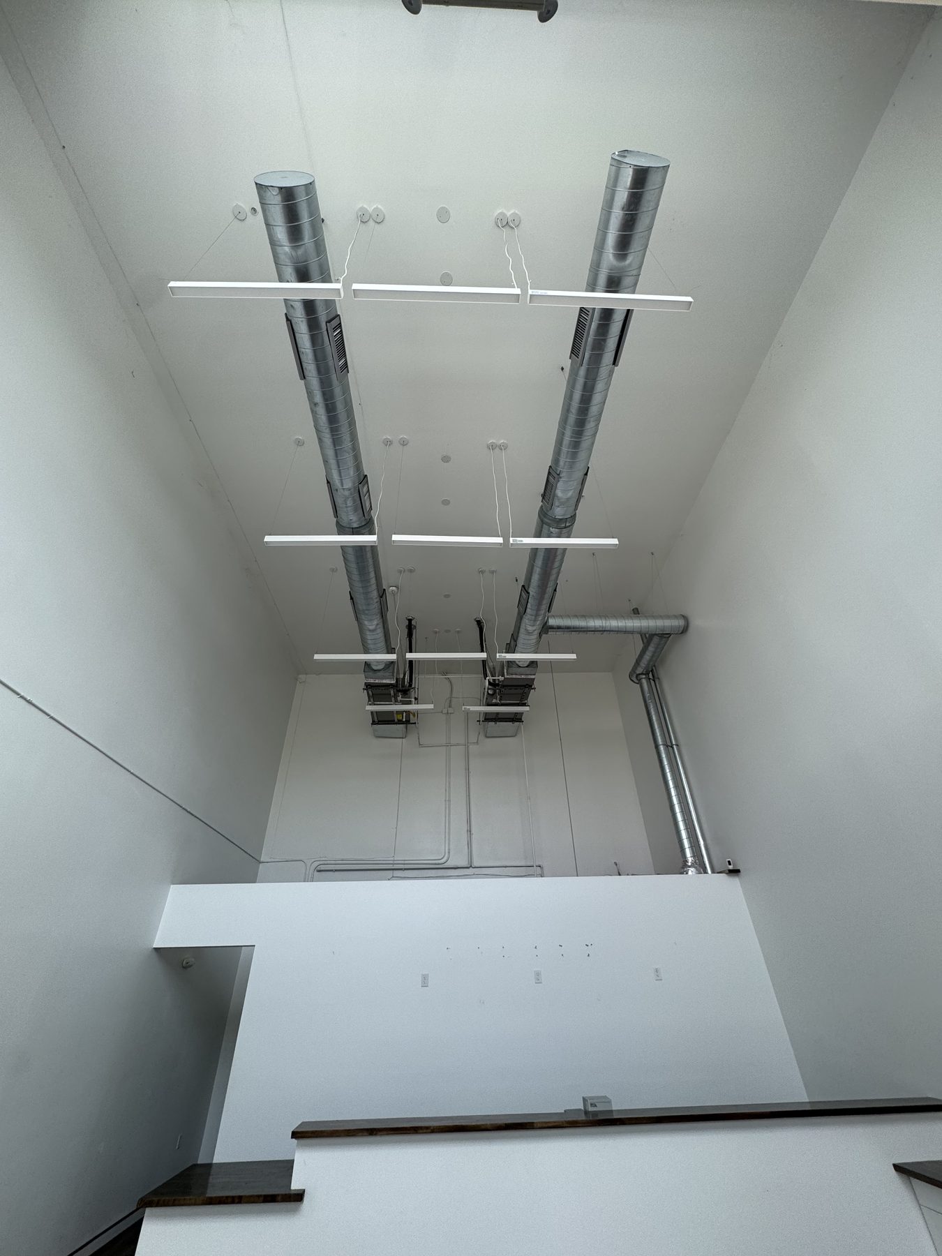 ~20′ ceiling and exposed duct